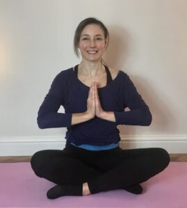 Jo's Pilates teacher in the Namaste pose